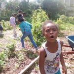 Kids Stop by Community Garden